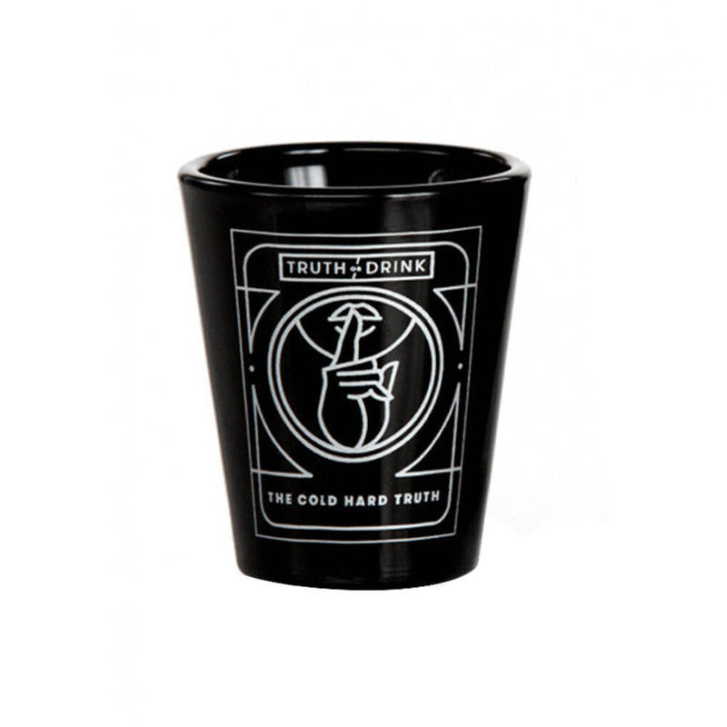 Black shot glass with white TRUTH DRINK text and a hand holding a lightning bolt logo below it centered on a white background